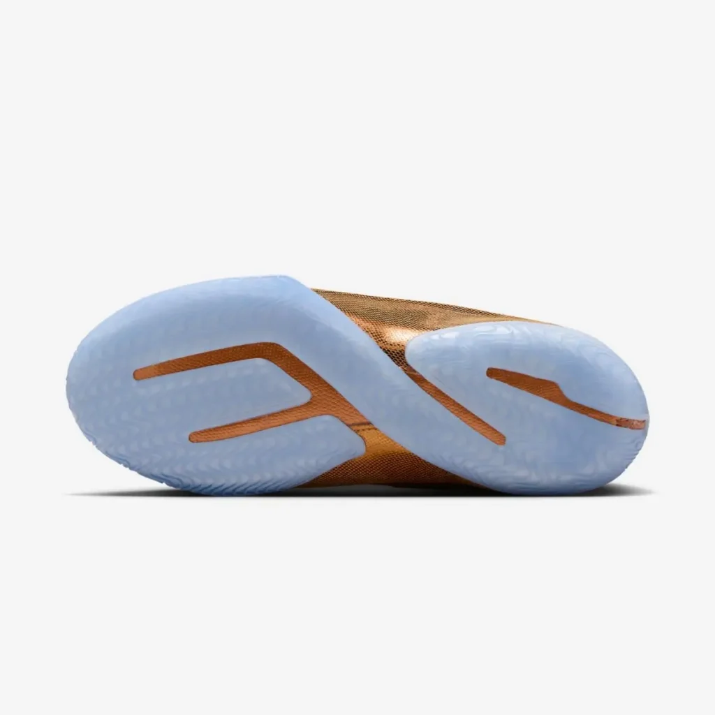 Bottom view of the Nike LeBron 23 “LeBronto” sneaker highlighting translucent icy blue rubber outsole with sculpted traction pattern and amber midfoot plate for court grip