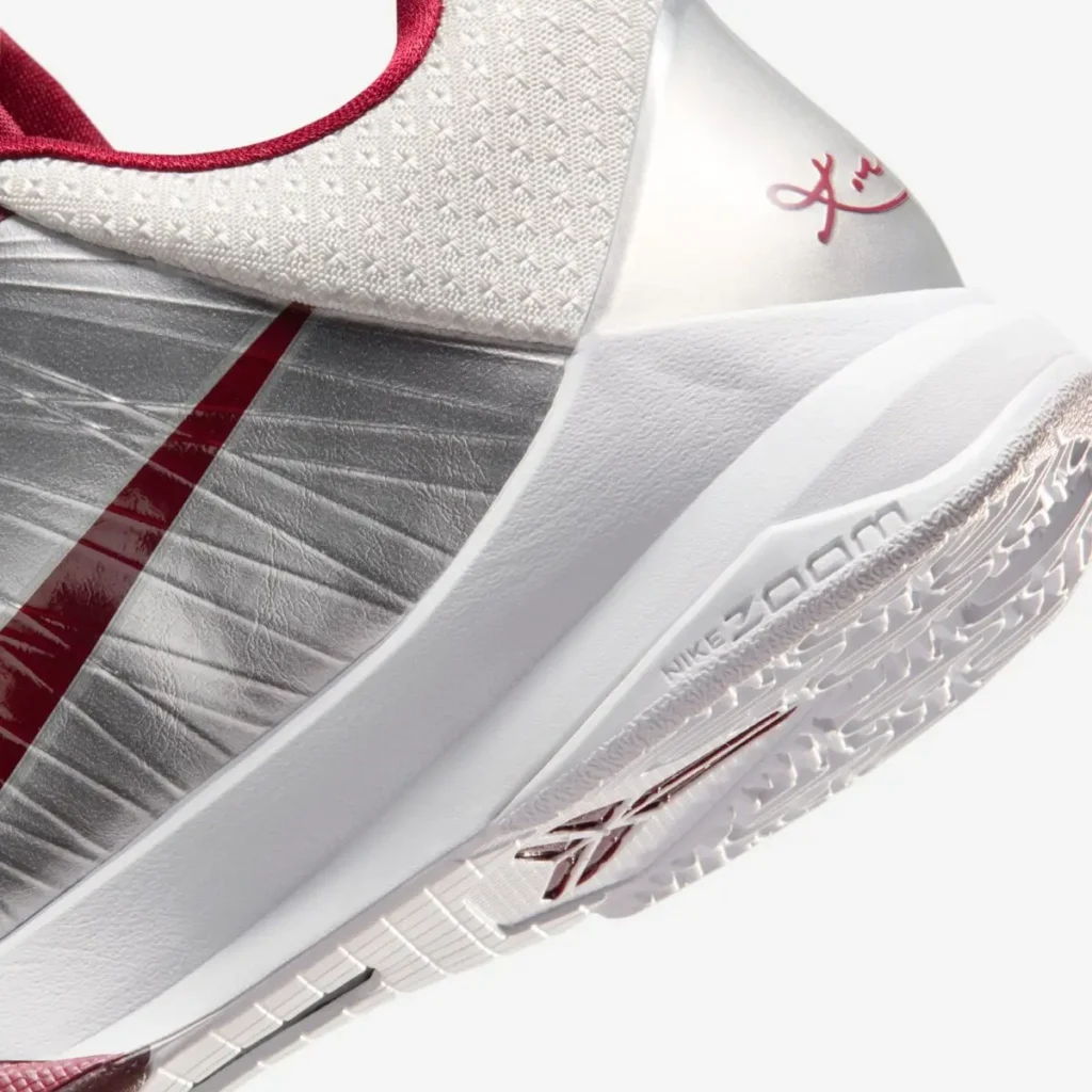 Close-up of the heel and midsole on the Nike Kobe 5 Protro “Lower Merion Aces” showing Kobe signature detail and Nike Zoom cushioning in metallic silver and team red