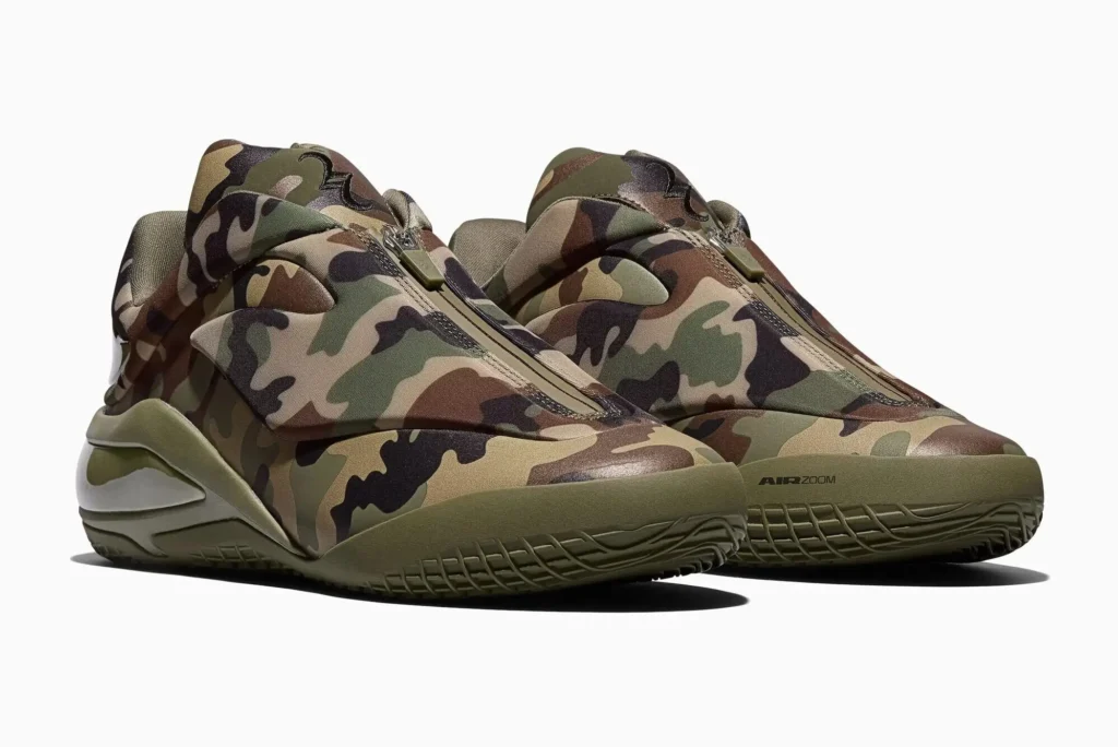 Front three-quarter view of the Converse SHAI 001 “Camo” basketball sneakers featuring a full camouflage upper, central zip closure, and olive-toned midsole with sculpted heel cushioning and textured outsole