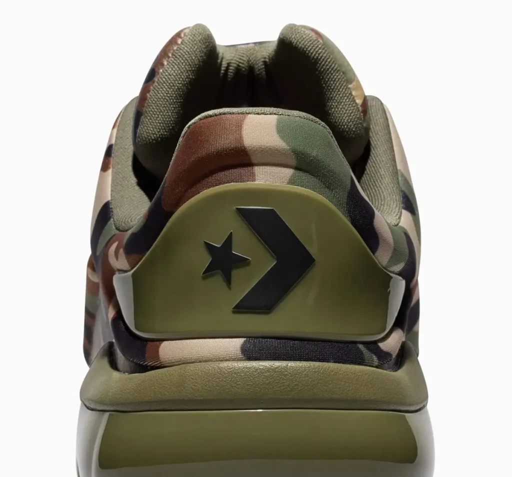 Rear close-up of the Converse SHAI 001 “Camo” showing padded collar, camouflage upper, and molded olive heel counter with black chevron-star logo branding