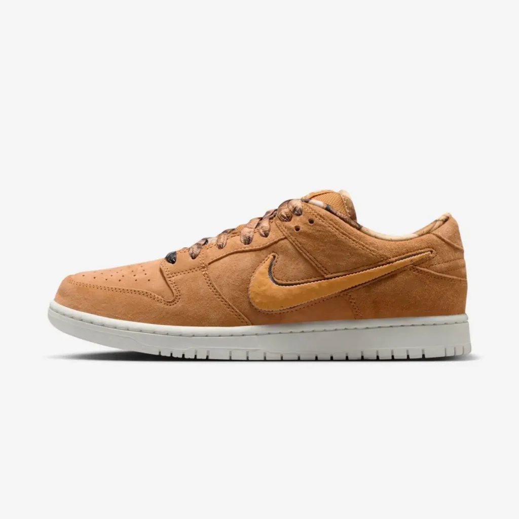 NOTE x Nike SB Dunk Low “Brew & Biscuits” sneaker in warm biscuit-brown suede with tonal overlays, textured Swoosh, and off-white sole, shown in lateral side profile against a clean studio background