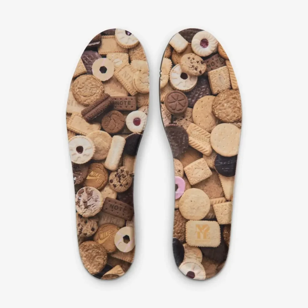 Insole graphic of NOTE x Nike SB Dunk Low “Brew & Biscuits” featuring an all-over collage of assorted biscuits and cookies in warm brown and cream tones, reinforcing the coffee-and-biscuit theme