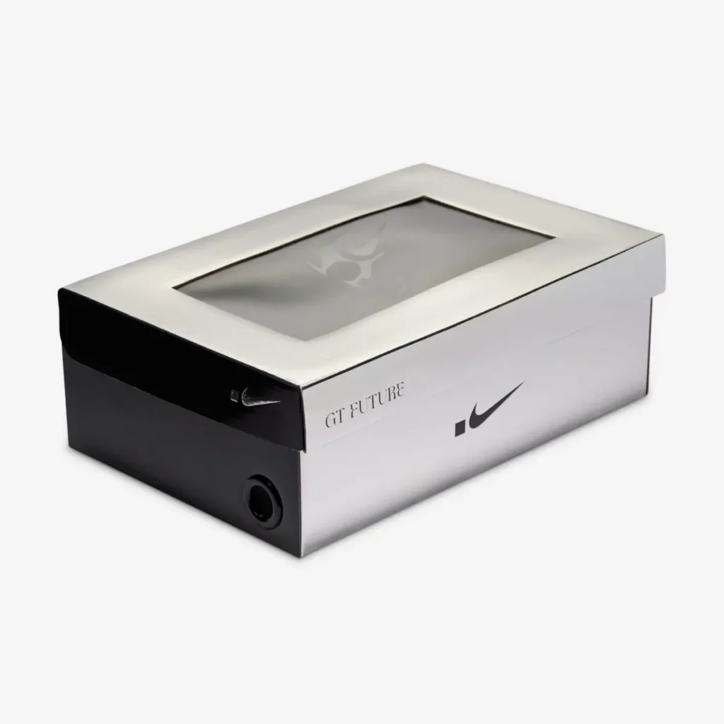 Nike G.T. Future packaging box in a sleek silver and black design, featuring a transparent display window with Swooshman graphic, minimalist Swoosh branding, and “GT FUTURE” text detailing