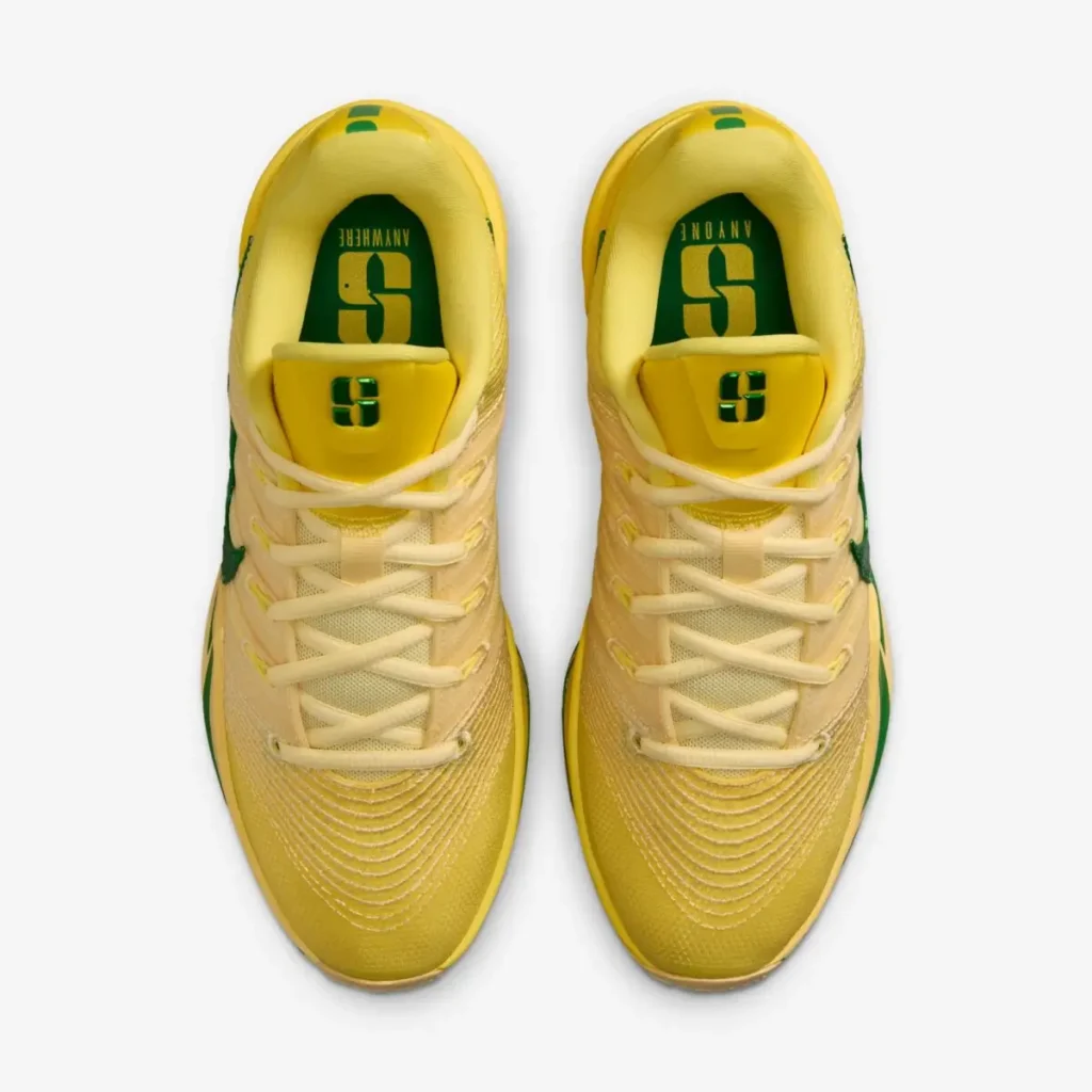 Top-down view of the Nike Sabrina 3 “Oregon Ducks” basketball shoes featuring yellow mesh uppers, cream laces, green Swooshes, and Sabrina Ionescu “S” logos on the tongue with green insoles