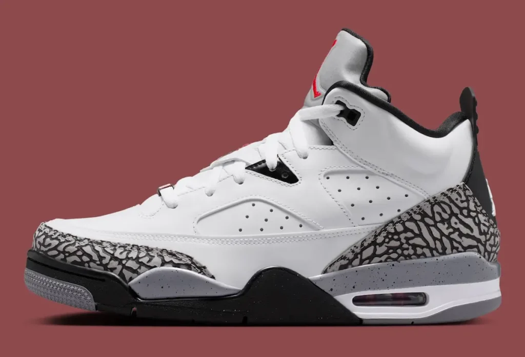Jordan Son of Mars “White Cement” sneaker in lateral side view featuring a white leather upper, grey elephant print overlays at the toe and heel, black midsole, visible Air unit, and red Jumpman branding