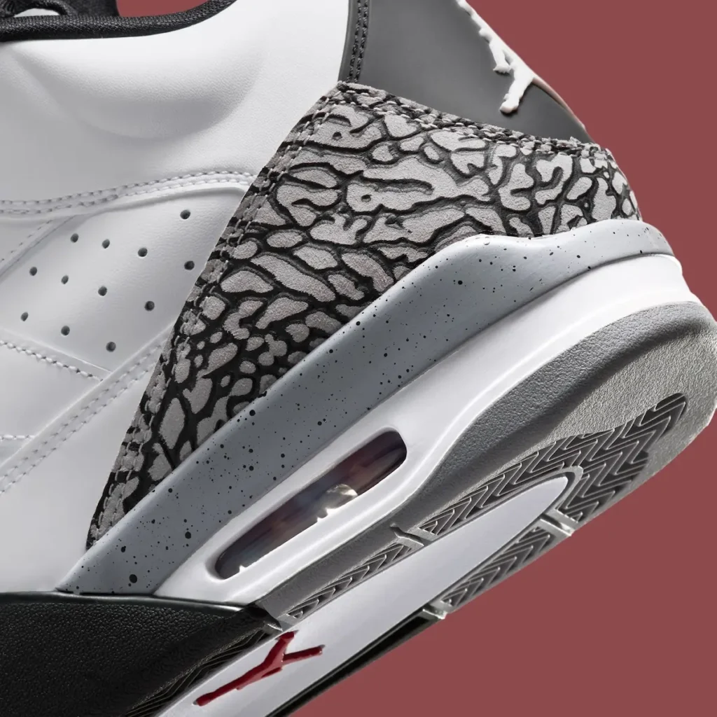Close-up of Jordan Son of Mars “White Cement” heel featuring grey elephant print overlay, speckled midsole with visible Air unit, and textured grey outsole with herringbone traction