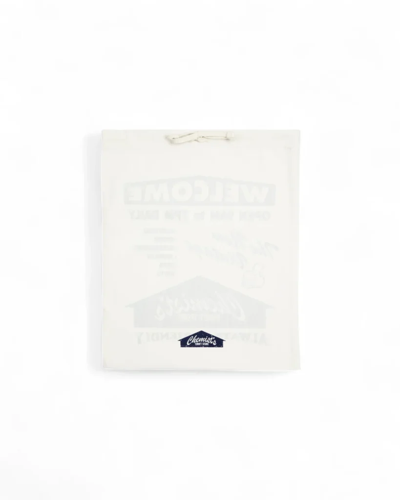 Chemist’s® Thrift Store translucent sneaker dust bag with drawstring closure and navy Chemist Creations logo printed at the bottom, used for packaging the AVIA 855 collab shoe