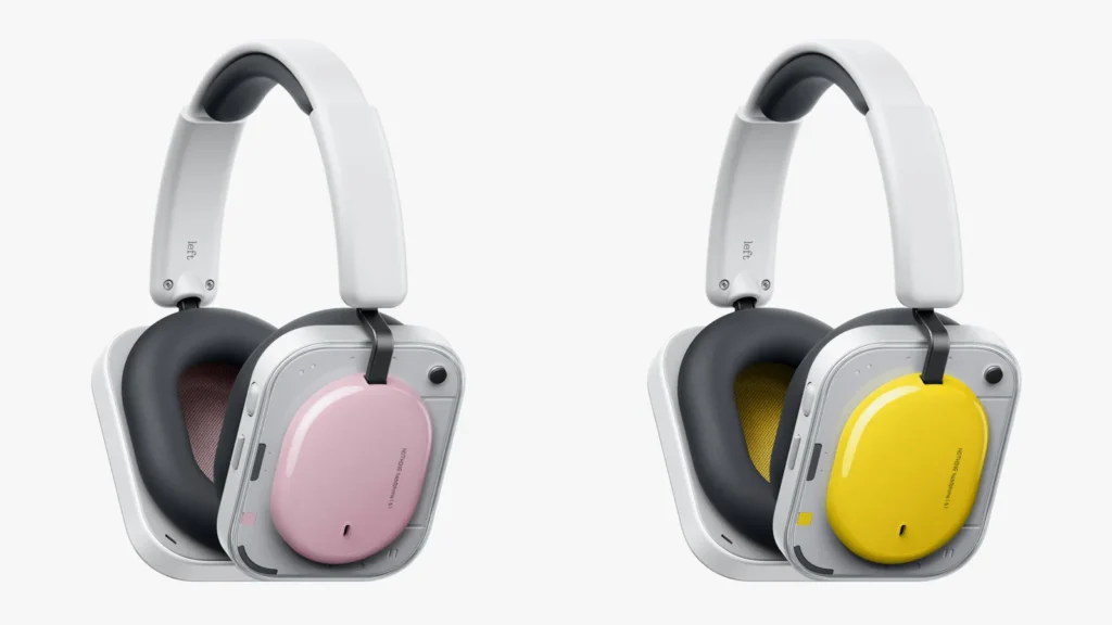 Two Nothing Headphone (a) over-ear headphones displayed side by side, featuring interchangeable ear cup covers in pastel pink and bright yellow, with transparent housing, cushioned black ear pads, and a minimalist white headband design