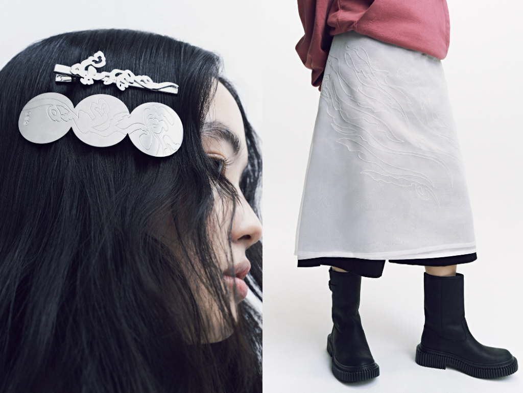 Split composition featuring, on the left, a close-up side profile of a model with long dark hair adorned with silver BTS “ARIRANG” hair clips engraved with flowing illustrative motifs, and on the right, a lower-body view of a model wearing a muted red top, a semi-sheer light grey skirt with subtle embroidered traditional patterns, and black mid-calf boots against a minimal studio background