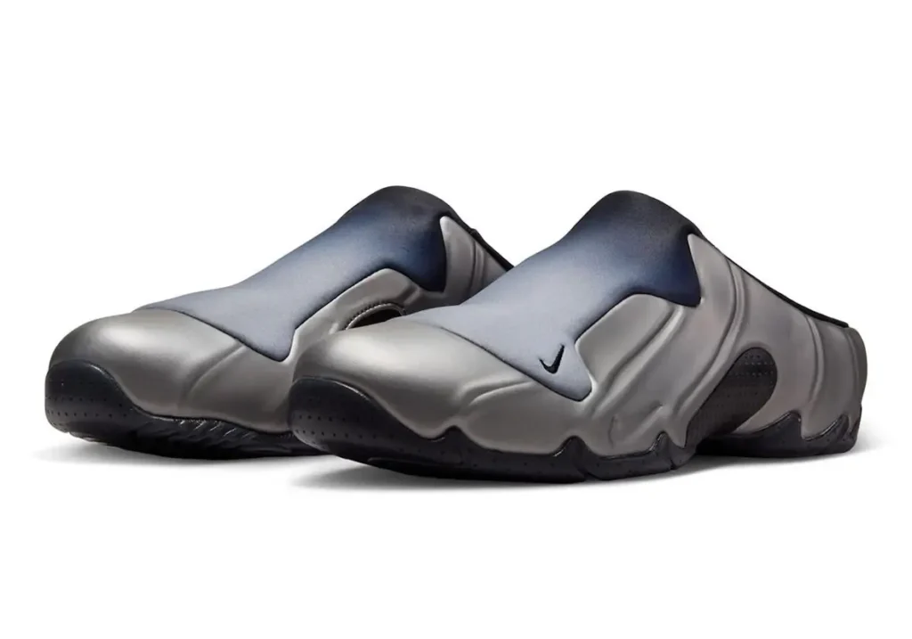 Angled pair view of Nike Clogposite “Metallic Dark Grey” highlighting the silver gradient shroud, sculpted metallic upper, and black outsole with subtle Swoosh detailing