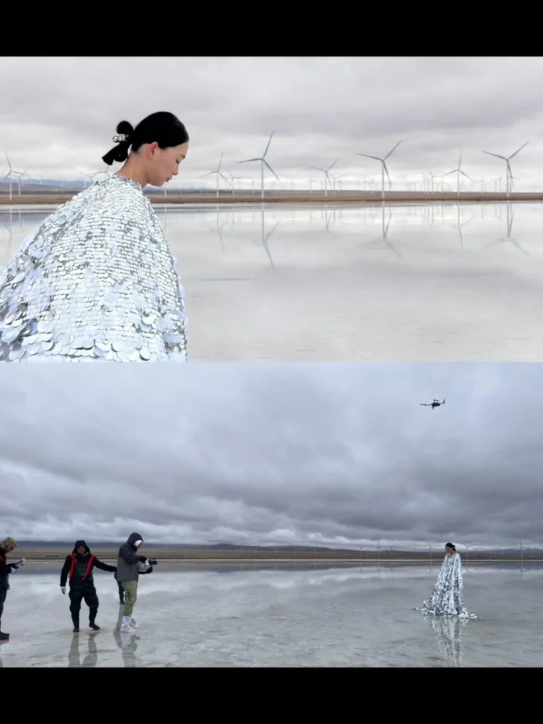 Model in a reflective silver sequin garment standing on a mirror-like salt lake during the PARCO Spring 2026 “Let Go, Let In” campaign shoot