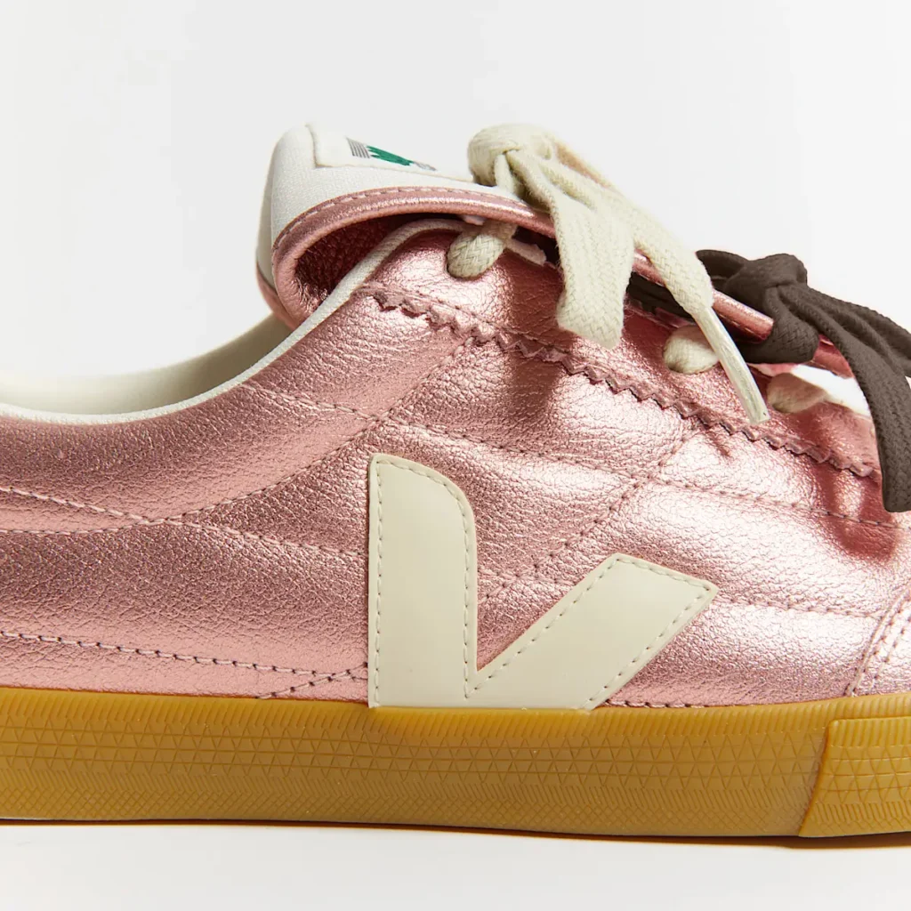 Close-up of Magliano x VEJA Panenka sneaker in pearlescent pink leather with cream V logo and gum rubber sole