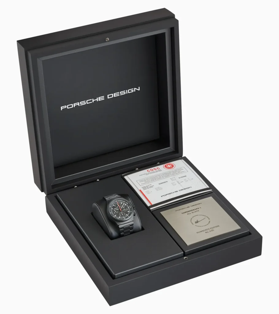 Porsche Design Chronograph 1 All Black Numbered Edition (2026) presented in official packaging box with watch, COSC certification, and numbered edition plaque displayed in a black presentation case