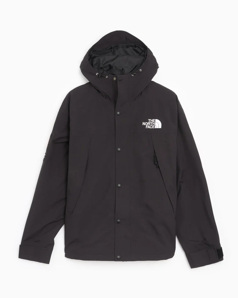 Black The North Face hooded rain jacket with snap-button front, adjustable hood, and white chest logo, shown front-facing on a neutral background