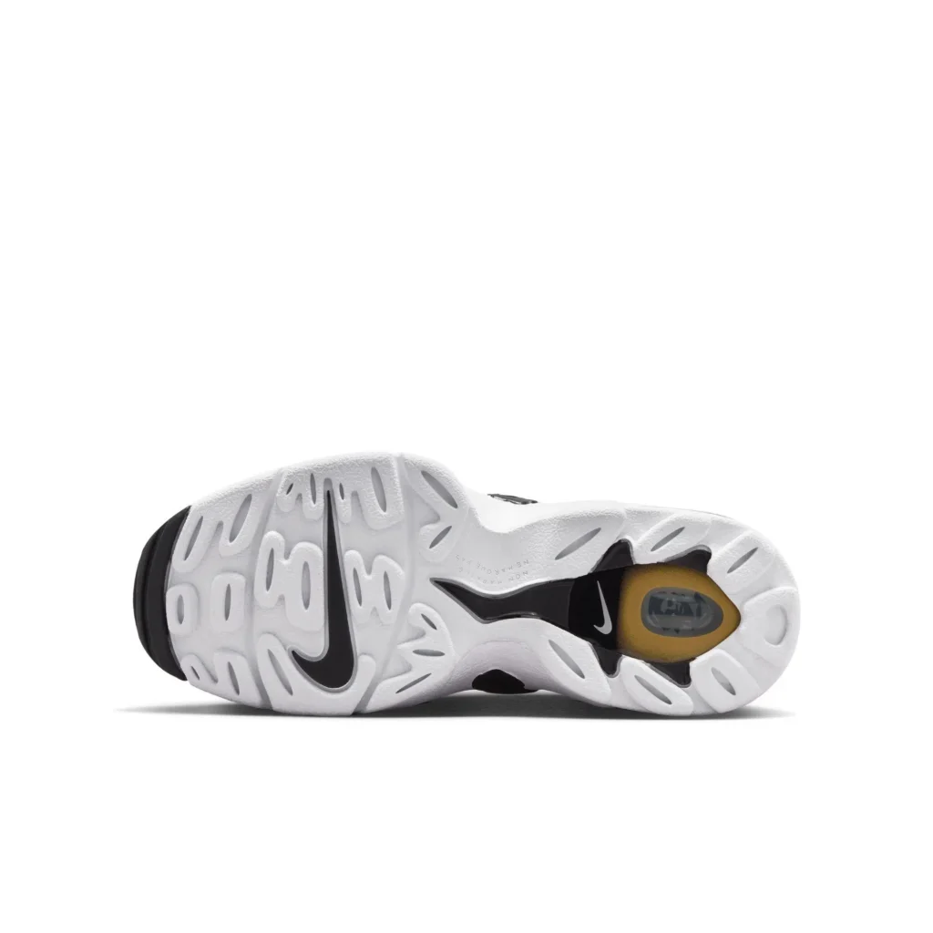 White rubber outsole of a Nike shoe shown from the bottom, featuring an organic, wavy traction pattern with oval cutouts. A black Swoosh logo runs along the midfoot, while a visible cushioning unit sits near the heel encased in a translucent amber-tinted window. Black rubber accents appear at the heel and midfoot for added grip, contrasting against the clean white base
