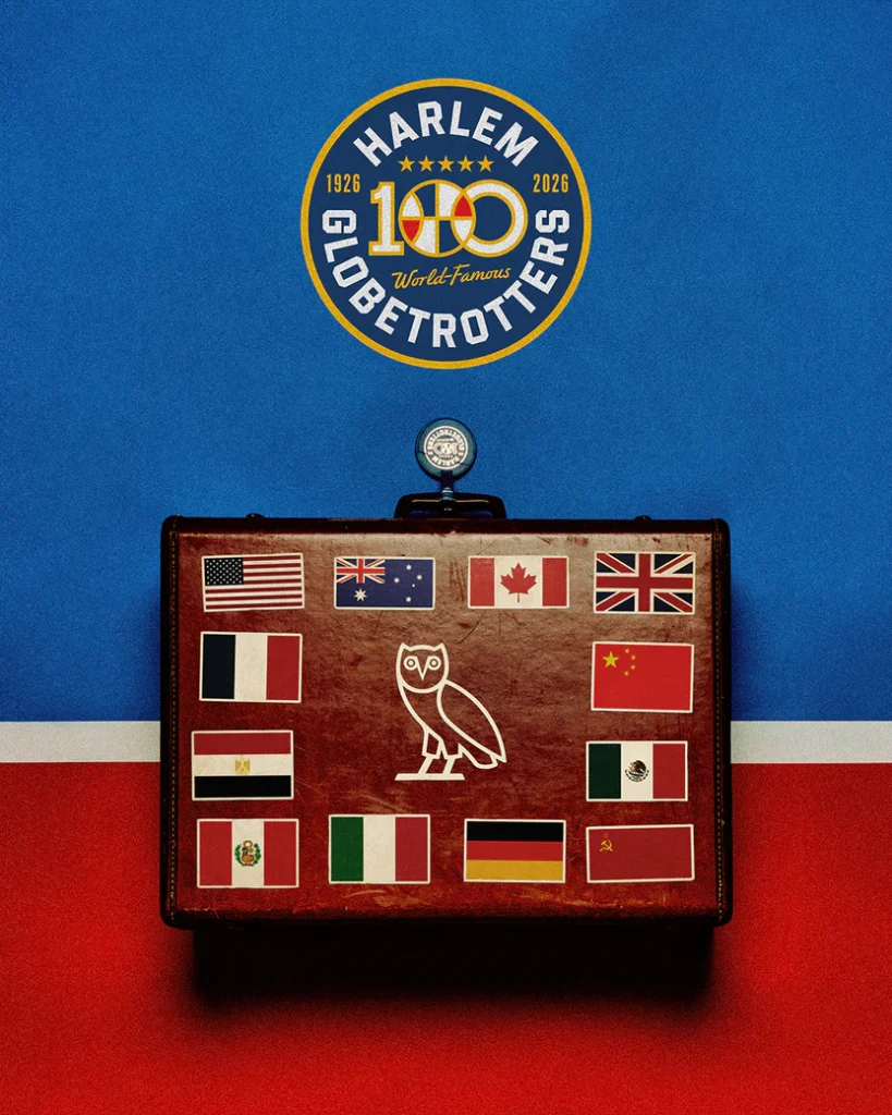 OVO x Harlem Globetrotters leather suitcase featuring the OVO owl logo and international flag decals, set beneath a “Harlem Globetrotters 100” centennial emblem against a blue backdrop