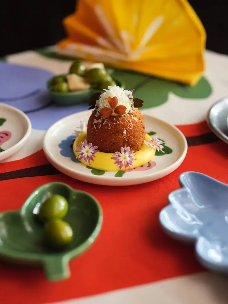 Stone Island NO SEASONS Milan Design Week 2026 poster featuring layered technical fabric textures in monochrome with the brand’s compass logo and bold typography, detailing public event dates and times at Capsule Plaza, emphasizing material innovation, archival references, and the concept of seasonless design