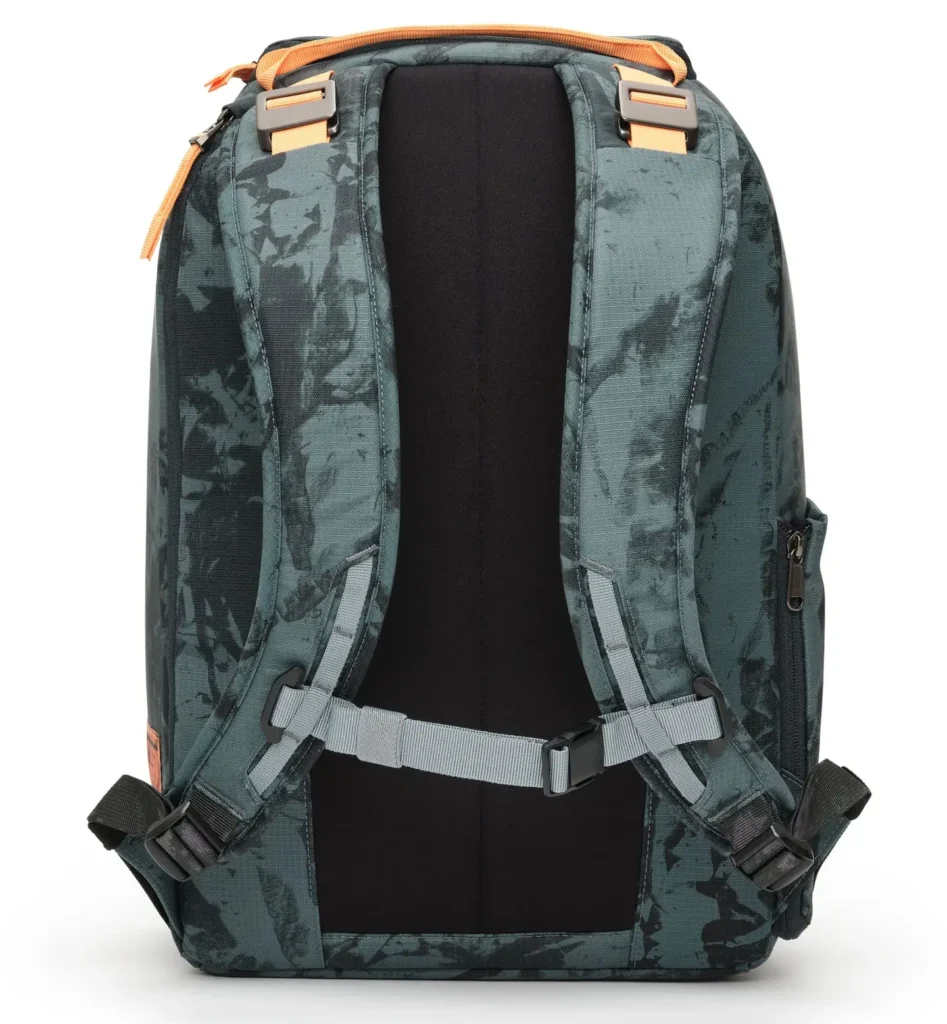The back view of a structured teal-green backpack featuring a tonal camo-style pattern. It has two padded shoulder straps with adjustable gray webbing and buckles, along with a horizontal sternum strap for added stability. The rear panel is cushioned with a black breathable mesh section designed for comfort and airflow. At the top, a reinforced carry handle and strap anchors are accented with orange detailing, maintaining the bag’s cohesive, utility-driven aesthetic