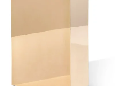 Minimalist product shot of a rectangular box with a smooth, reflective gold finish, photographed against a clean, neutral background. The sharp edges and mirror-like surface emphasize a premium, luxury packaging aesthetic with no visible branding or text