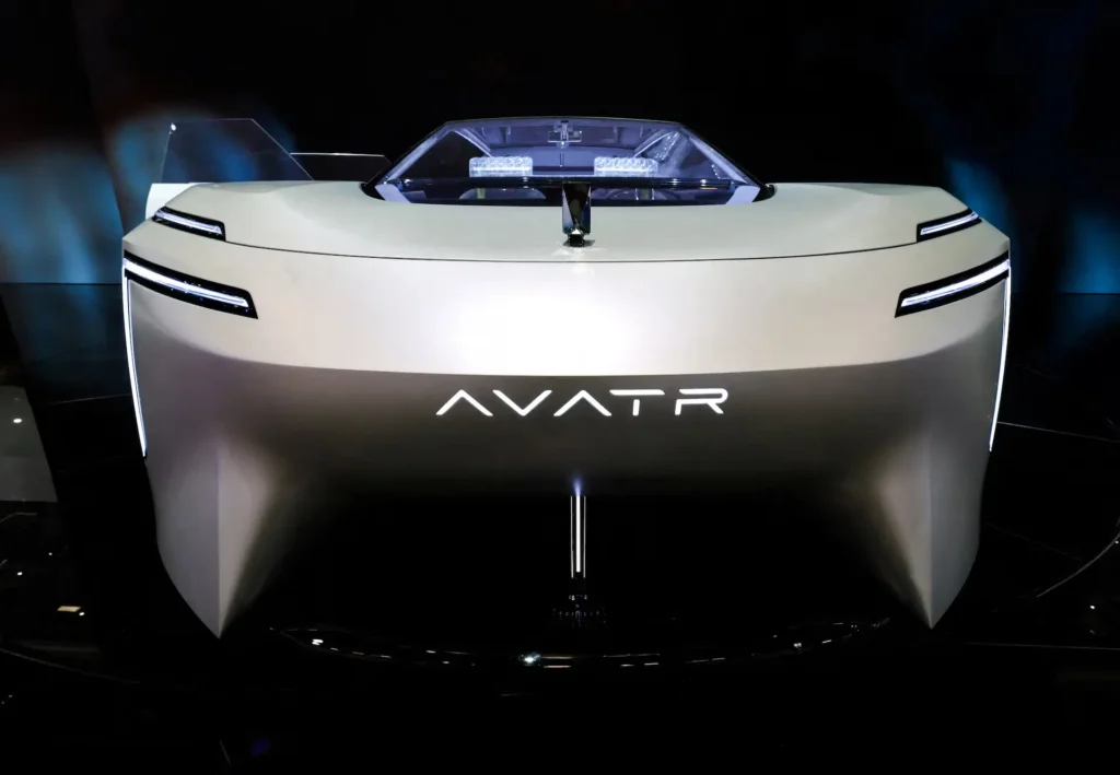 Front-facing view of an AVATR concept electric vehicle at Auto China 2026, featuring a sculptural minimalist body, illuminated AVATR logo, ultra-slim LED light strips, and a futuristic open-cabin design displayed under exhibition lighting