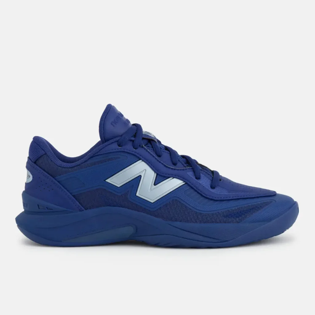 Side profile of New Balance KAWHI V basketball shoe in blue with sculpted midsole, layered upper, and metallic “N” logo detail