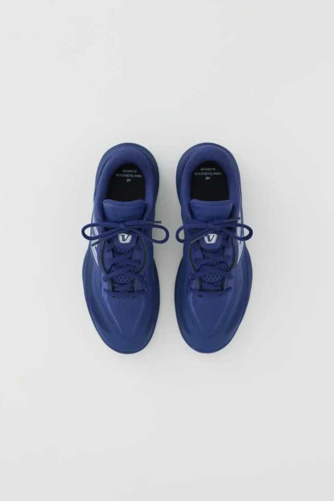 Top-down view of New Balance KAWHI V in blue showing lace structure, perforated toe box, and streamlined performance upper in a symmetrical layout
