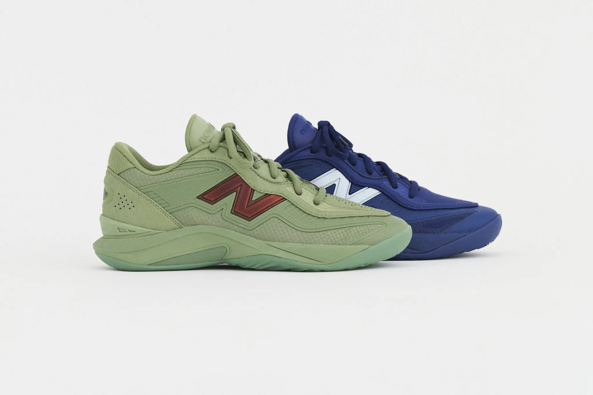 Two New Balance KAWHI V basketball shoes in green and blue colorways shown side by side, highlighting sculpted midsoles, layered uppers, and contrasting “N” logo details