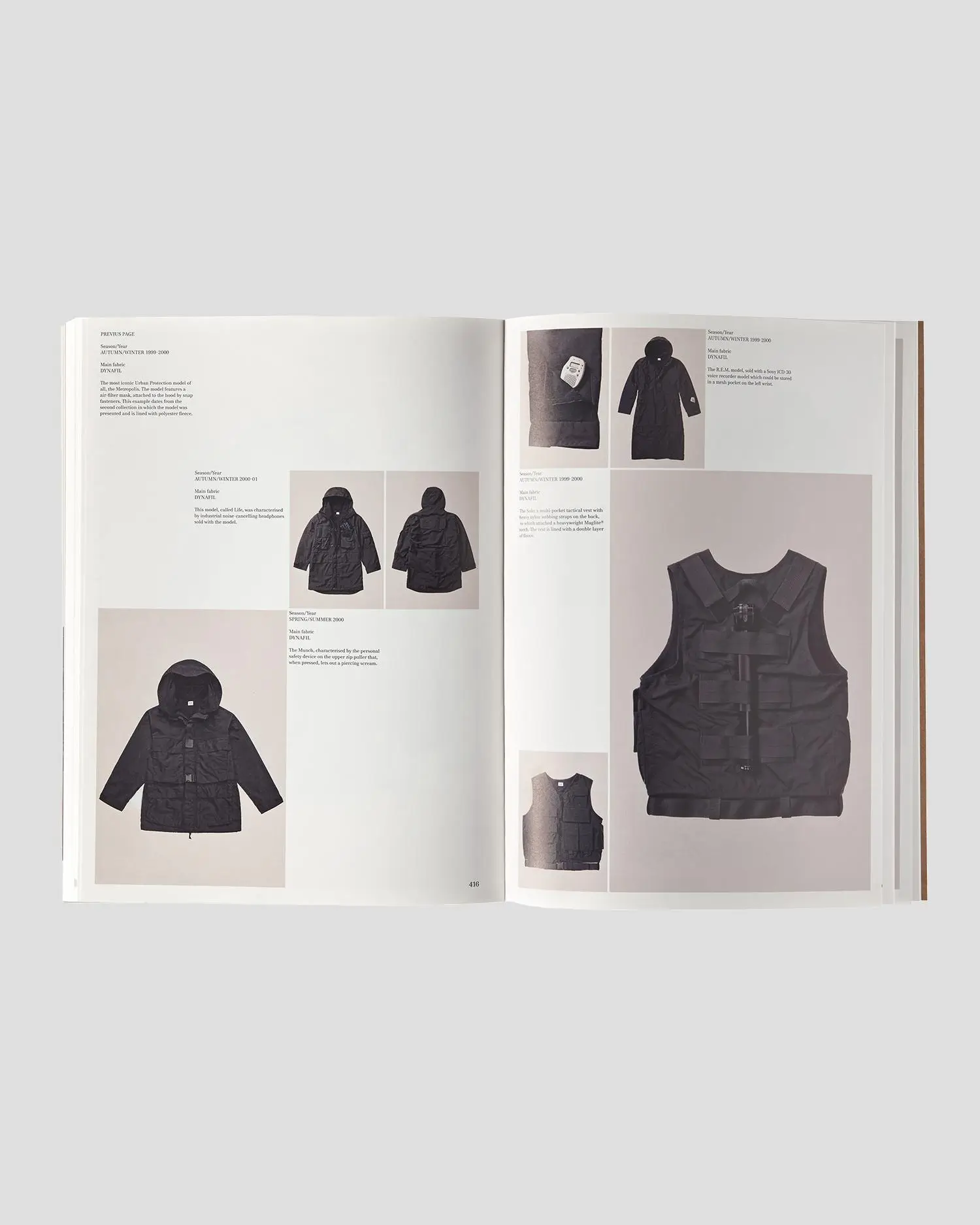 Open spread of a fashion archive book featuring C.P. Company garments, including technical jackets and a black utility vest, with annotated layouts and seasonal references displayed across both pages