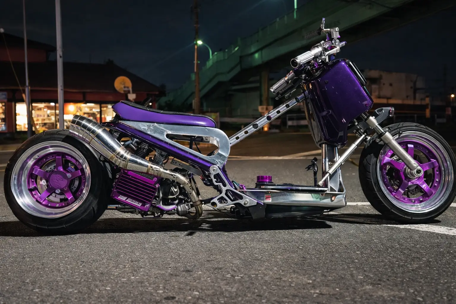 A heavily customized scooter with a stretched frame and exposed components sits on a nighttime city street, featuring a purple and chrome color scheme with oversized wheels and a polished exhaust system