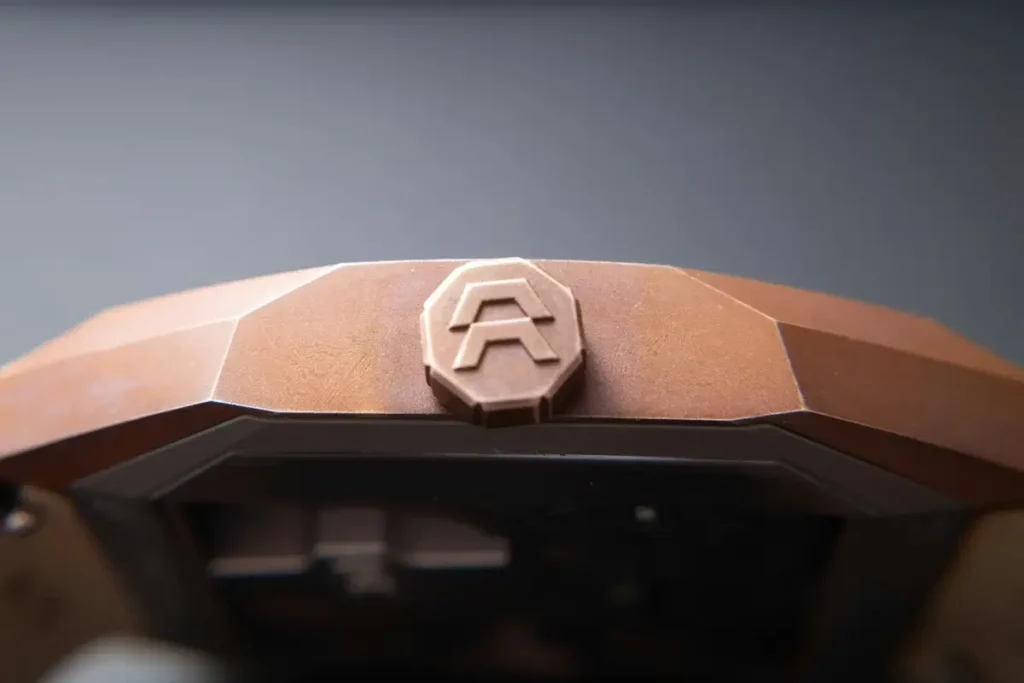 Macro detail of Alto Art 01 crown featuring engraved logo and angular case geometry