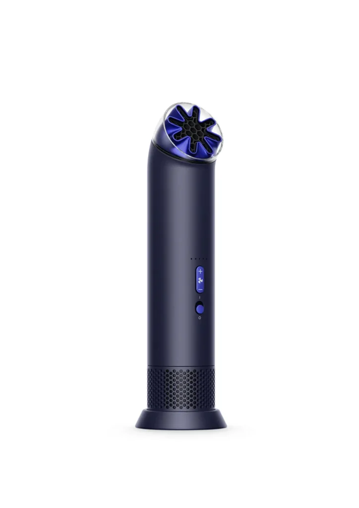 Compact handheld cooling device by Dyson in a deep navy and cobalt finish, featuring a precision star-shaped airflow nozzle engineered to reduce turbulence and noise while delivering focused air projection, with front controls and a perforated intake base forming the HushJet Mini Cool’s streamlined, high-performance design