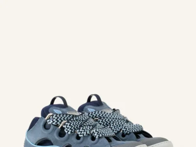 Pair of Lanvin Curb shoe in blue suede on a white background, featuring oversized silhouette, cutout panels, thick chevron-pattern laces, and chunky rubber soles