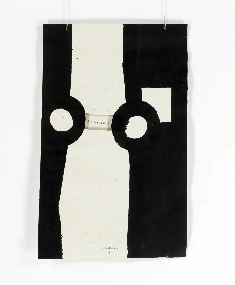 Abstract Eduardo Chillida artwork “Gravitation (Homage to Balenciaga)” featuring bold black geometric forms on paper with cut-out circular elements and a central opening, suspended against a neutral background, emphasizing balance, tension, and spatial interplay between void and mass