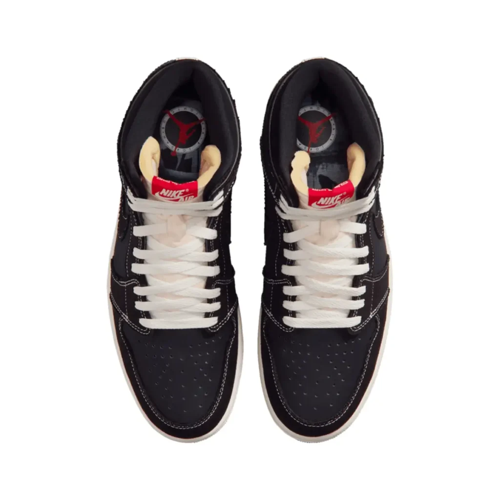 Top-down view of the Air Jordan 1 High OG “Flight Club” (2026) pair showing black leather uppers with white contrast stitching, white laces, exposed foam tongues with red Nike Air tags, and graphic insoles with Jumpman logo
