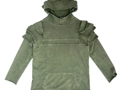 Front view of LUEDER Khaki Knight Hoodie SS26 in faded khaki green, designed with medieval armor-inspired construction including reinforced chest paneling, sculpted shoulder layers, a high protective collar, and a relaxed body with kangaroo pocket