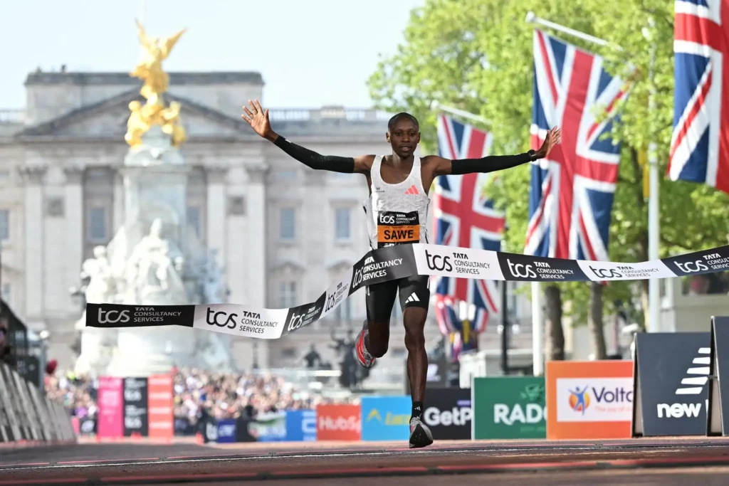 Sabastian Sawe breaking the tape to win the 2026 London Marathon in front of Buckingham Palace