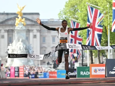 Sabastian Sawe breaking the tape to win the 2026 London Marathon in front of Buckingham Palace