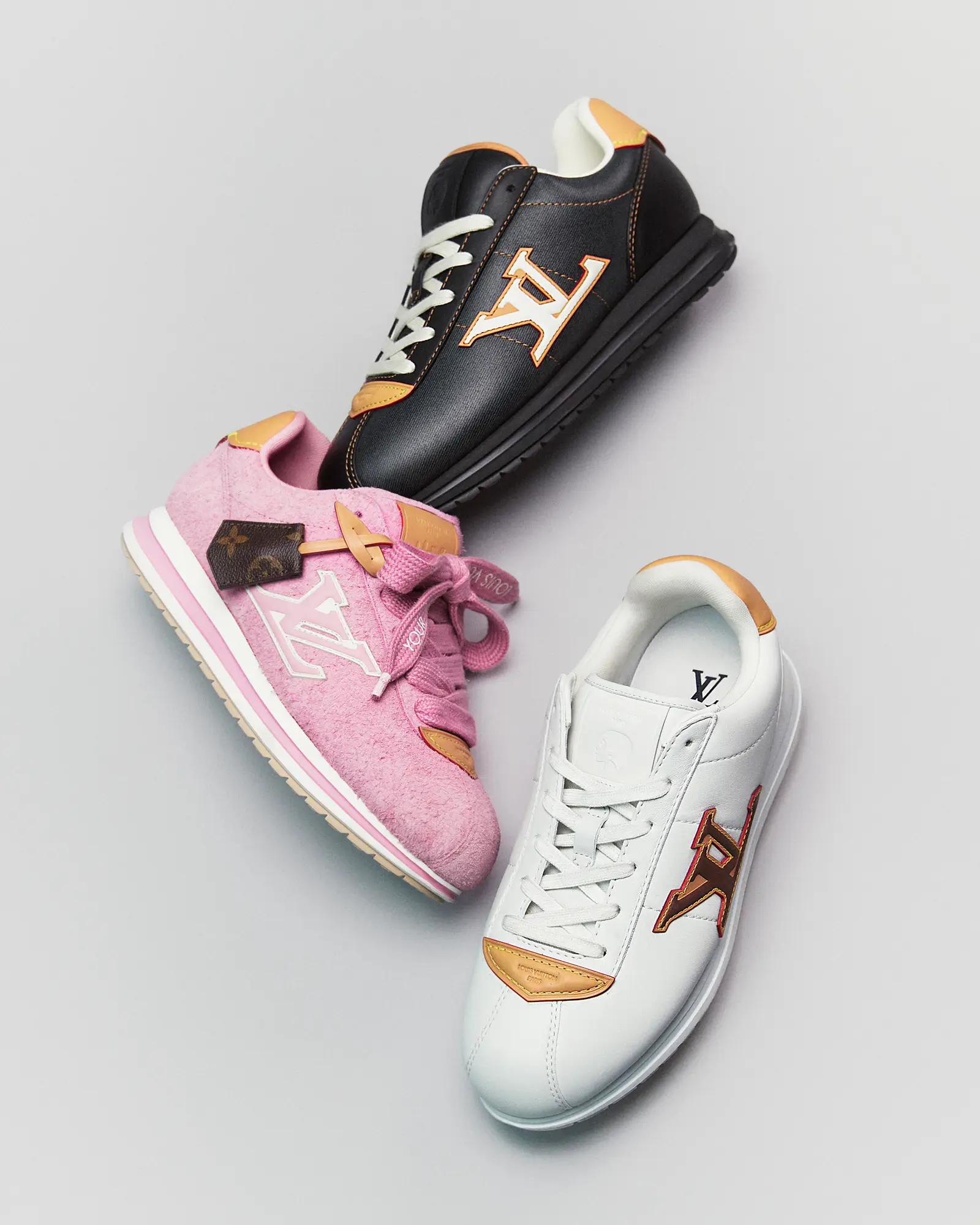 Louis Vuitton LV Buttersoft sneakers in rose, black, and white colorways with signature monogram accents designed by Pharrell Williams and j-hope