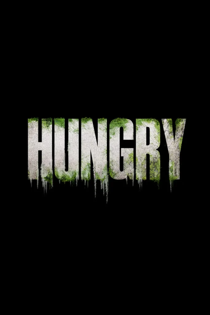 Bold, distressed title “HUNGRY” centered on a black background, the letters textured like cracked stone with mossy green growth and dripping, decay-like streaks, evoking horror and organic unease