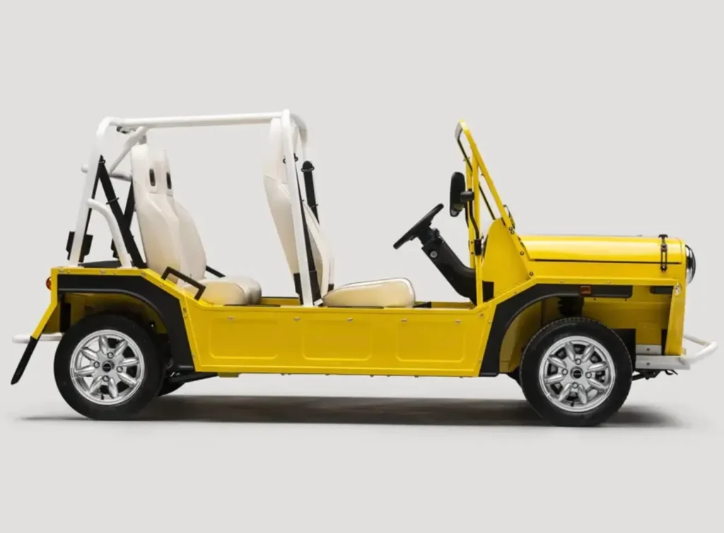 Side profile of MOKE GEN 1 EV in bright yellow, featuring open-air body design, exposed frame, minimal panels, and compact electric vehicle proportions