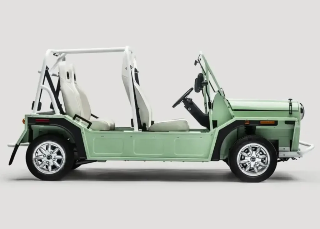 Side profile of MOKE GEN 1 EV in light green, showcasing open-air design, exposed frame, minimal body panels, and compact electric vehicle proportions
