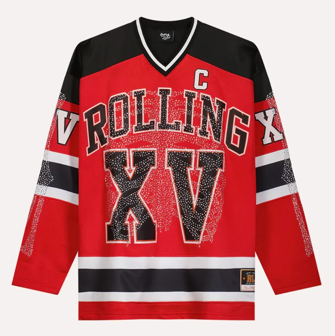 Red and black Rolling Loud BONES hockey jersey with oversized “ROLLING XV” lettering, rhinestone embellishments across the chest, striped sleeves, and captain “C” patch on the upper chest