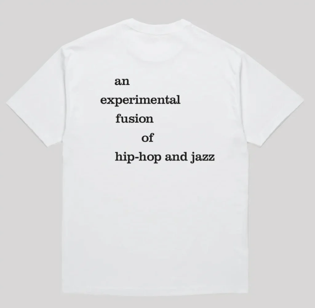 White Skate Muzik t-shirt back print with 'an experimental fusion of hip-hop and jazz' in black lettering. Clean Jazzmatazz tribute merch from Milan