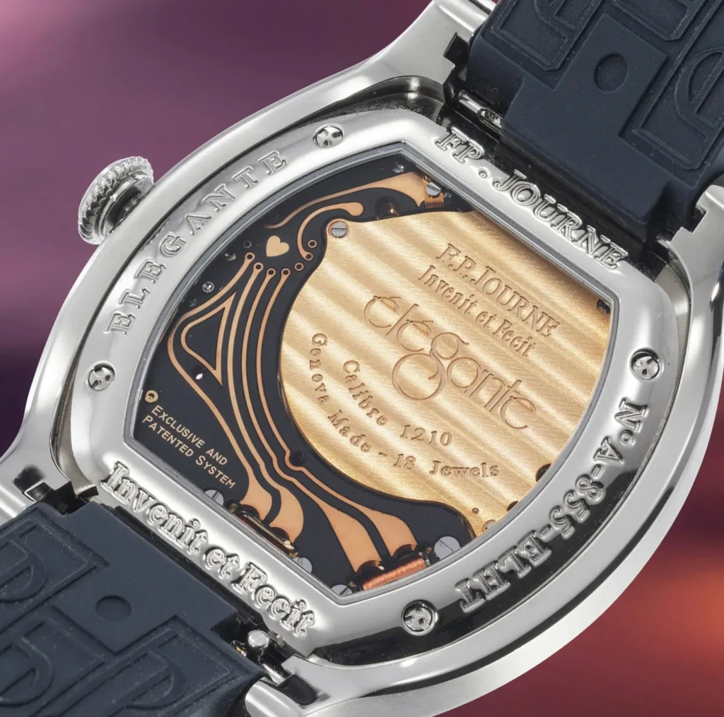 F.P. Journe Élégante 48 caseback showing Calibre 1210 electro-mechanical movement with gold-toned bridge, engraved “Élégante” text, visible circuitry, and rubber strap attached to titanium tortue-shaped case