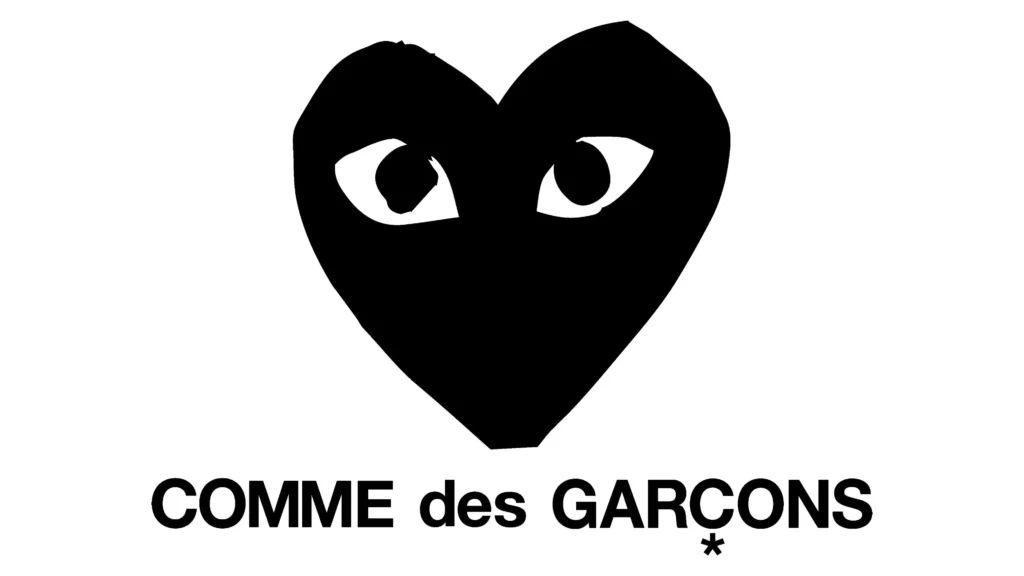 Black heart logo with stylized eyes above “COMME des GARÇONS” text in bold monochrome, representing the iconic Comme des Garçons Play identity