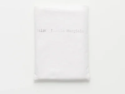 Maison Martin Margiela SS2011 Men’s Lookbook front cover — white fabric with raw edges and minimalist branding