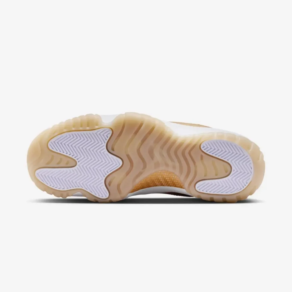 Translucent gum rubber outsole of a low-top sneaker featuring wavy traction grooves, with white herringbone grip pods at the forefoot and heel, shown from a bottom view against a clean neutral background