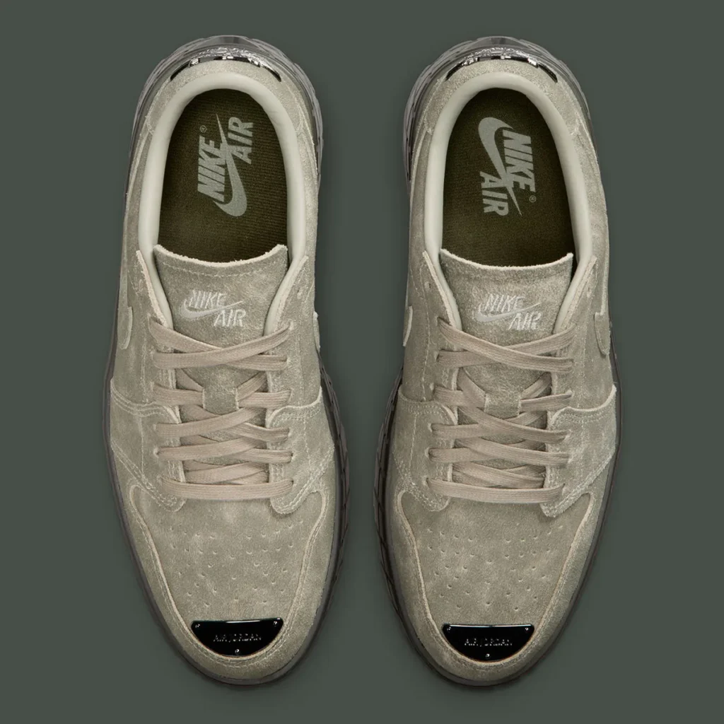 Top-down view of the Air Jordan 1 Low Brooklyn “Cargo Khaki” pair, showcasing suede uppers in muted khaki tones, tonal laces, perforated toe boxes, Nike Air branding on the tongue and insoles, padded collars, and metallic toe accents at the front