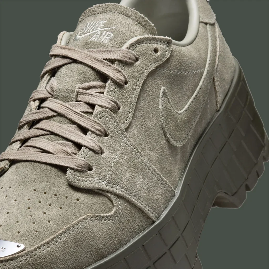 Air Jordan 1 Low Brooklyn “Cargo Khaki” close-up highlighting soft suede upper across the toe box, eyestays, and side panels, with tonal laces, stitched Swoosh, subtle Nike Air branding on the tongue, and thick olive platform midsole with textured sidewall detailing