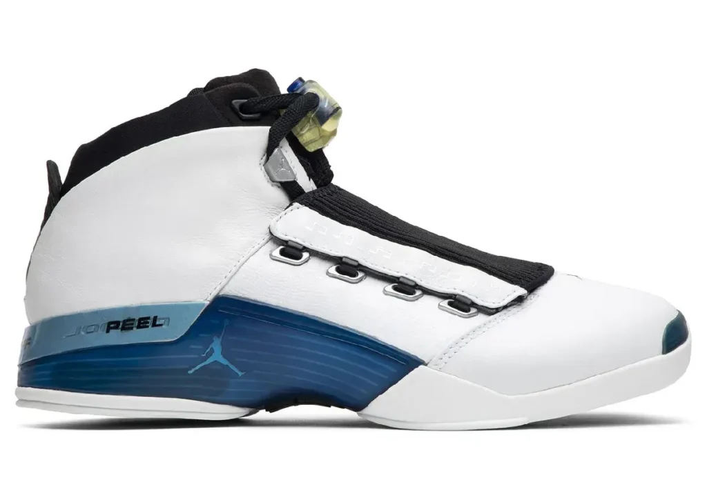 Air Jordan 17 “College Blue” shoe in white full-grain leather with blue midsole accents, black removable shroud, chrome lace hardware, and translucent lace lock, shown in lateral side profile